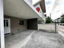 Covered garage area next to residential house