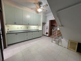 Spacious kitchen with ample cabinetry and under-stair storage