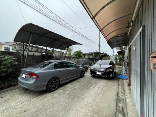 Outdoor garage with parked cars