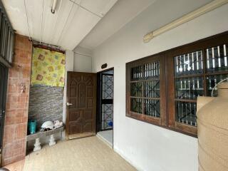 Entryway to the property with tiled flooring and a wooden door