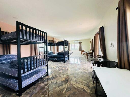 Spacious bedroom with multiple bunk beds and large windows