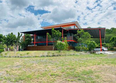 Exterior view of a modern two-story house with large outdoor space