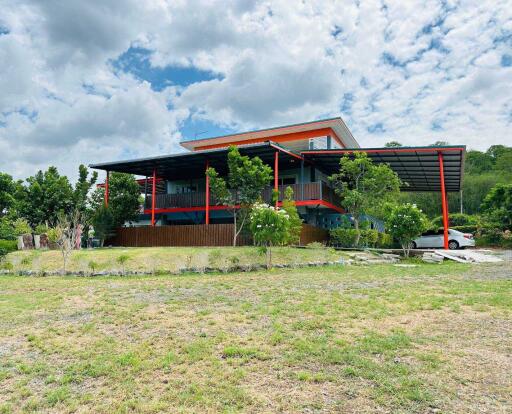 Exterior view of a modern two-story house with large outdoor space