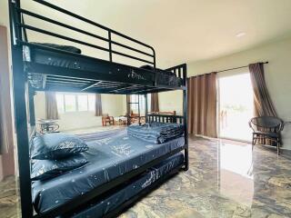 Bedroom with bunk bed and large windows