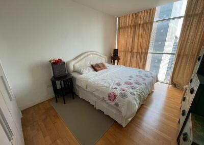 Modern bedroom with large window and wooden floors