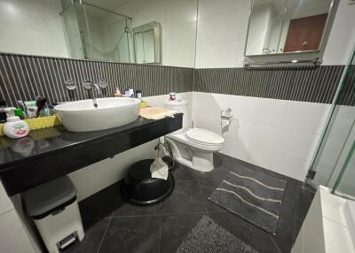 Modern bathroom with sink, toilet, and shower