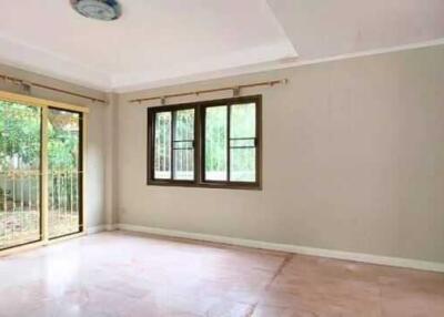 Spacious living room with large windows and sliding door to garden