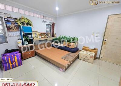 Bedroom with bed, shelves, and boxes