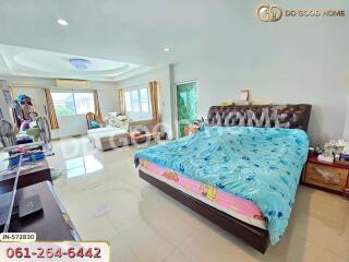 Spacious bedroom with large bed and seating area