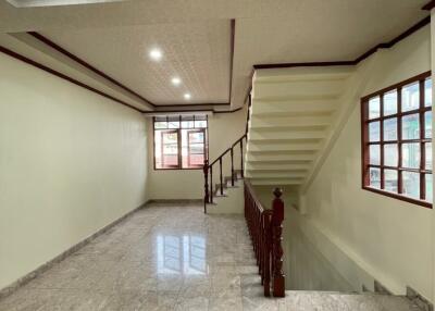 Main living area with staircase and windows