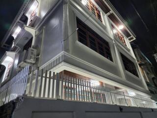 Exterior of a modern multi-story building at night