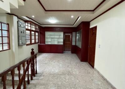 Spacious living room with marble flooring and wooden accents.