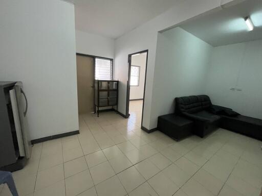 Living room with minimalistic furniture and tiled floor