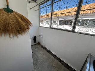 Utility room with windows and a broom