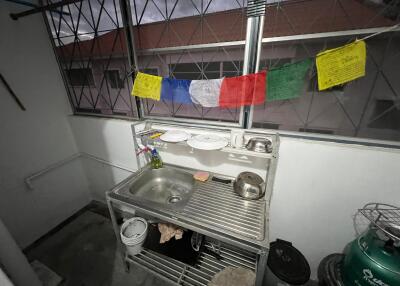 compact simple kitchen with stainless steel sink area