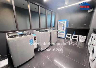 Modern laundry room with multiple washing machines and utilities