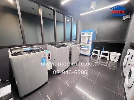 Modern laundry room with multiple washing machines and utilities