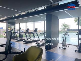 Modern gym with equipment and pool view