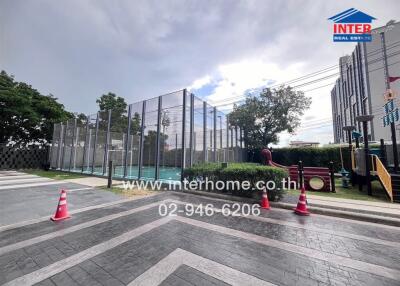 Outdoor recreational area with tennis court