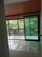 Living area with large windows and balcony