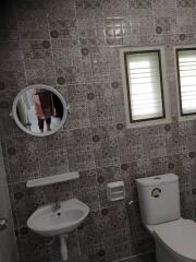 Bathroom with tiled wall and basic fixtures