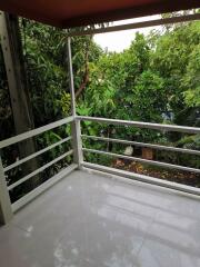 Outdoor balcony with a view of lush greenery