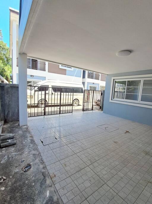 Covered garage with tiled floor and metal gate