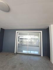 Covered patio area with tiles and sliding glass doors