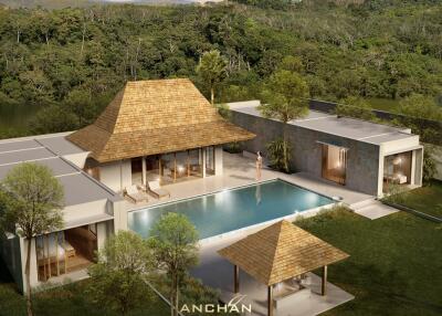 Aerial view of a luxurious villa with a pool and lush greenery