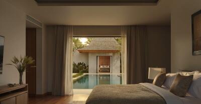 Cozy bedroom with a view of a private swimming pool