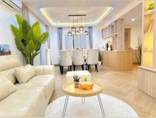 Modern living room and dining area with stylish lighting and decor