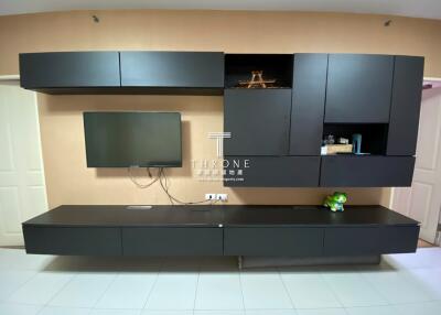 Modern living room with mounted TV and sleek black cabinetry