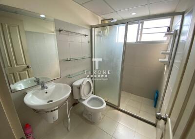 Modern bathroom with white fixtures and sliding glass shower door