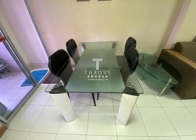 Modern dining room with glass table and black chairs