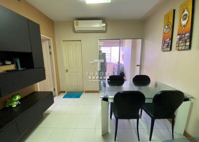 Modern dining area with glass table and black chairs