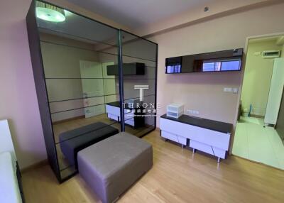 Modern bedroom with mirrored wardrobe and storage units