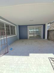 Covered patio area with tiled flooring and sliding glass doors