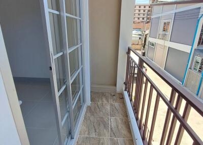 Small balcony with tiled flooring and metal railing