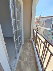 Small balcony with tiled flooring and metal railing