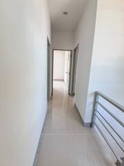 Bright hallway with clean tiles and railing