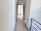 Bright hallway with clean tiles and railing