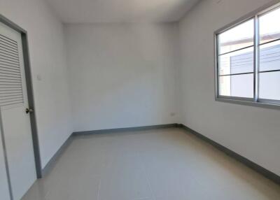 Empty bedroom with large window and closet