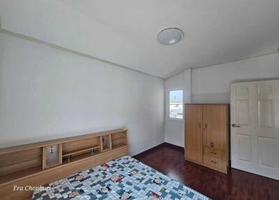 Simple and clean bedroom with wooden floor and furniture