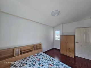 Simple and clean bedroom with wooden floor and furniture