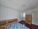 Simple and clean bedroom with wooden floor and furniture