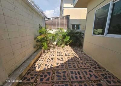 Outdoor area with tiled flooring and plants