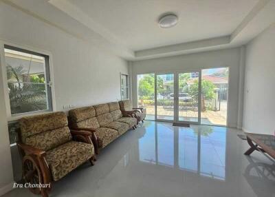 Spacious living room with large windows and modern seating