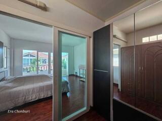 Spacious bedroom with large windows and mirrored wardrobe