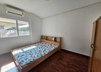 Spacious bedroom with wooden furniture