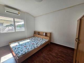 Spacious bedroom with wooden furniture